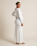 White jersey maternity maxi dress with asymmetric draped shoulder, designed for maternity photoshoots.