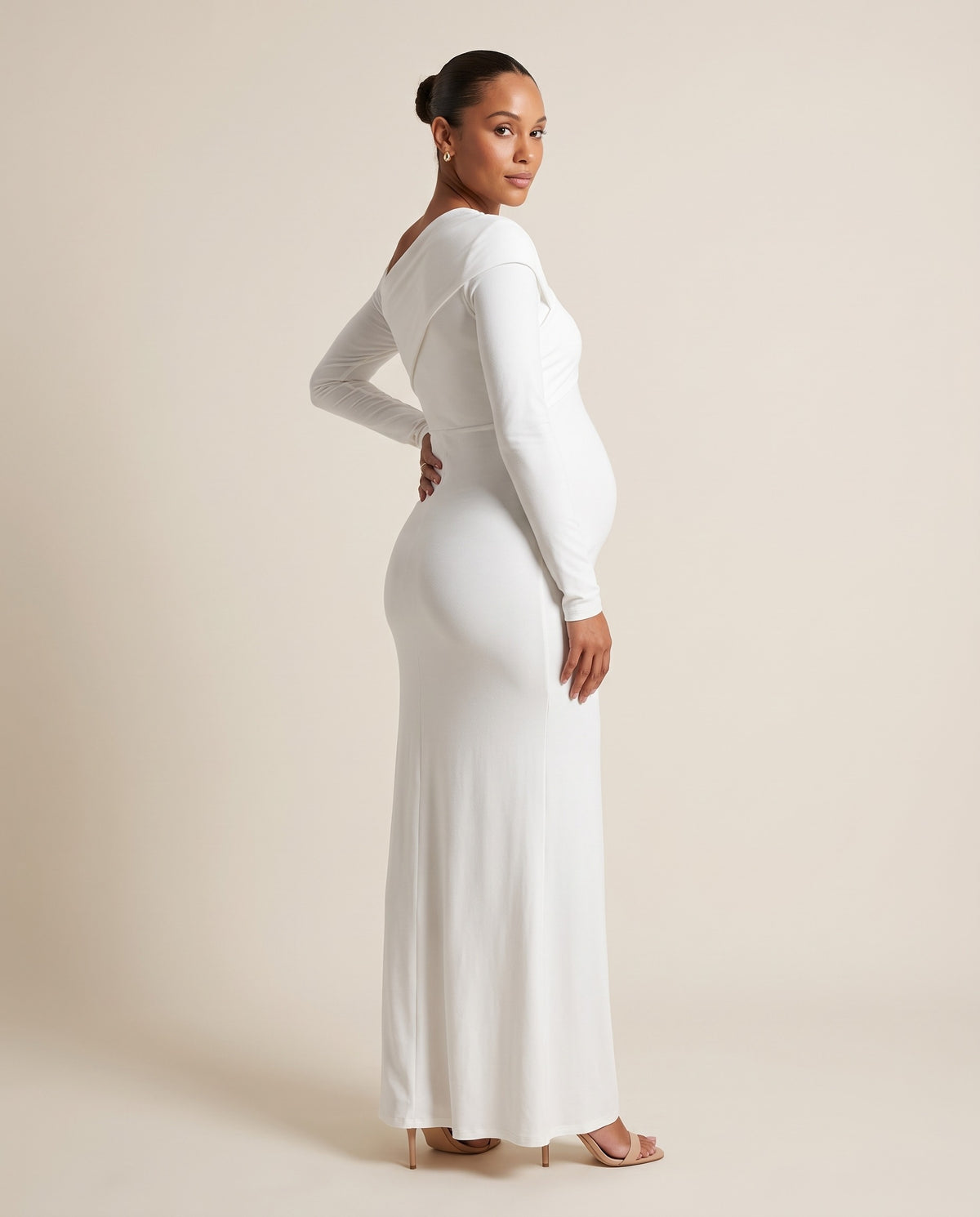 White jersey maternity maxi dress with asymmetric draped shoulder, designed for maternity photoshoots.