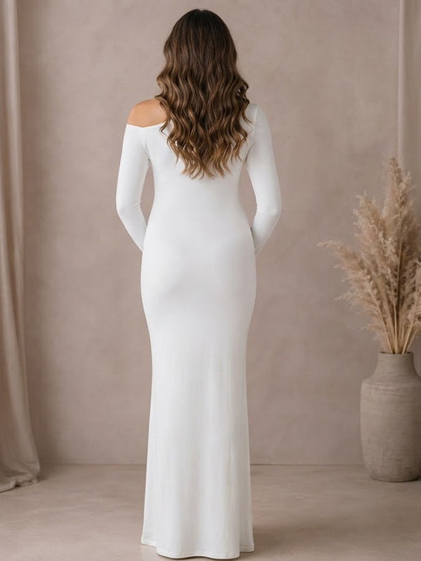 Back view of white jersey maternity maxi dress with asymmetric twisted neckline and long sleeves, designed for maternity photoshoot.