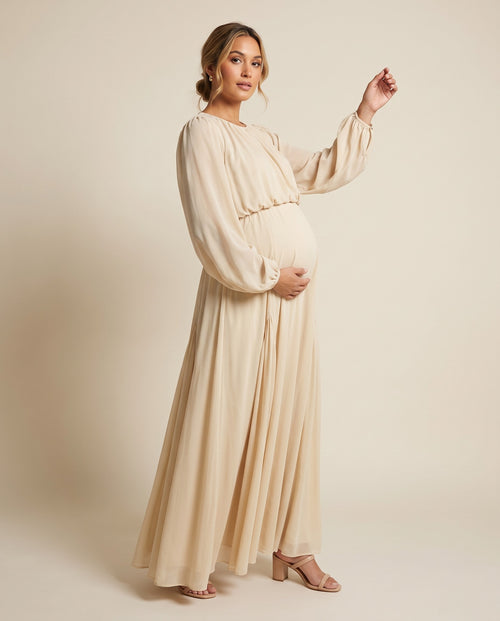 Ivory chiffon maternity maxi dress with balloon sleeves and flowing skirt, designed for baby shower and maternity photoshoots.