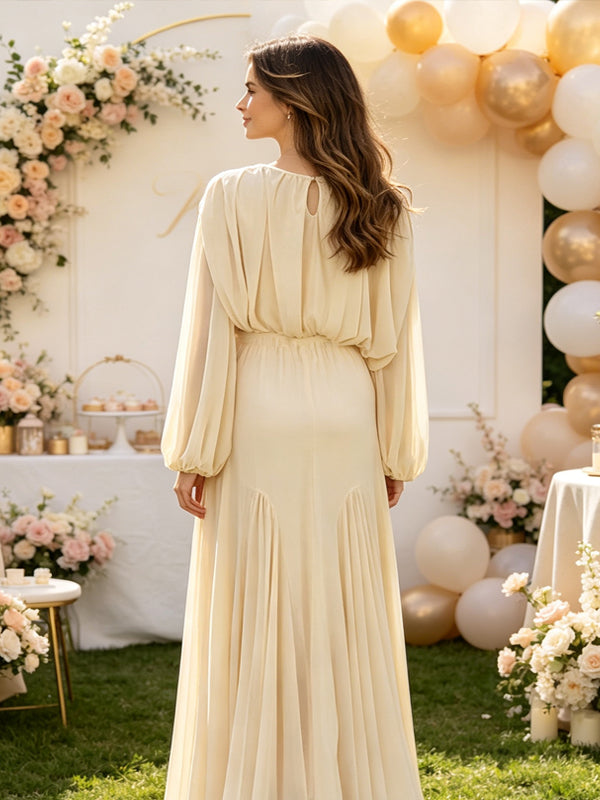 Back view of ivory chiffon maternity maxi dress with gathered neckline, long balloon sleeves and flowing skirt, designed for baby shower.