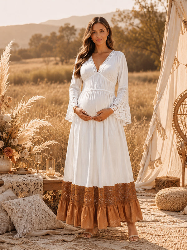 White boho maternity maxi dress with lace-trimmed V-neck, lace bell sleeves and contrast lace ruffle hem, designed for maternity photoshoot.
