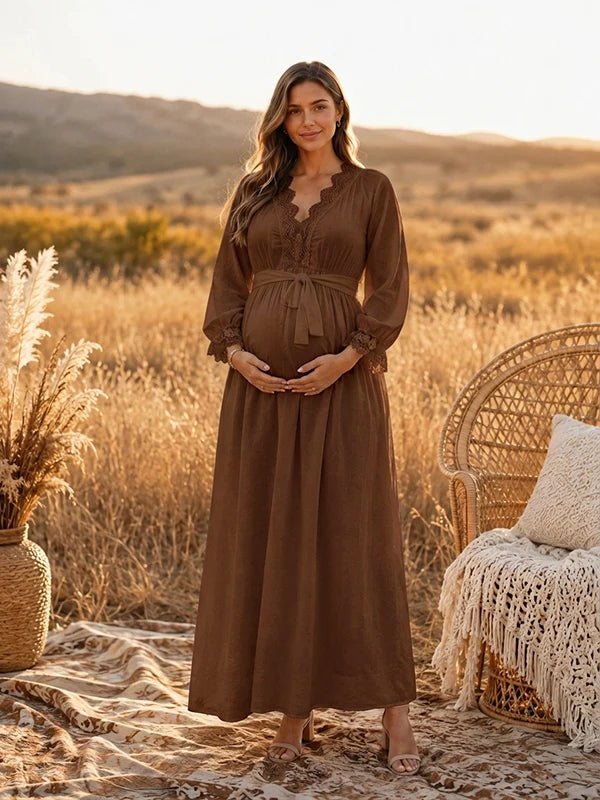 Brown boho maternity maxi dress with lace-trimmed V-neck, long sleeves and tie waist, designed for maternity photoshoot.