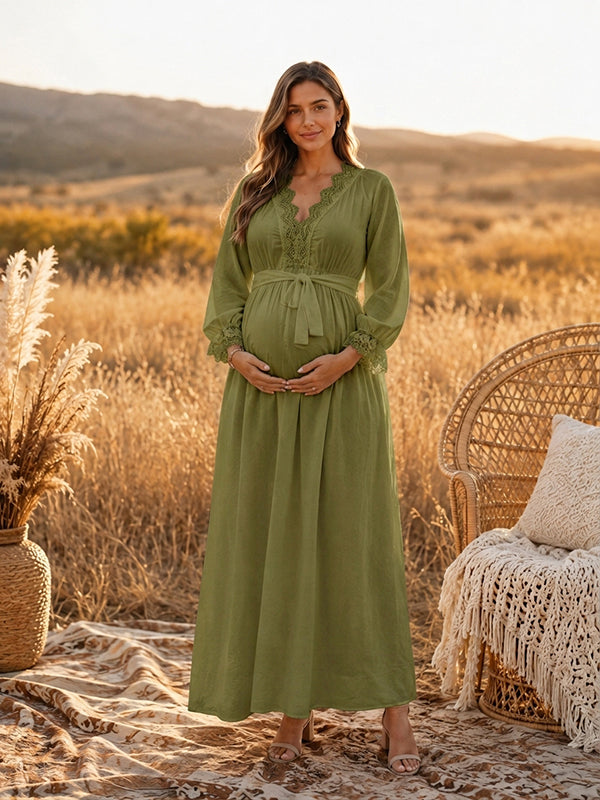 Green boho maternity maxi dress with lace-trimmed V-neck, long sleeves and tie waist, designed for maternity photoshoot.