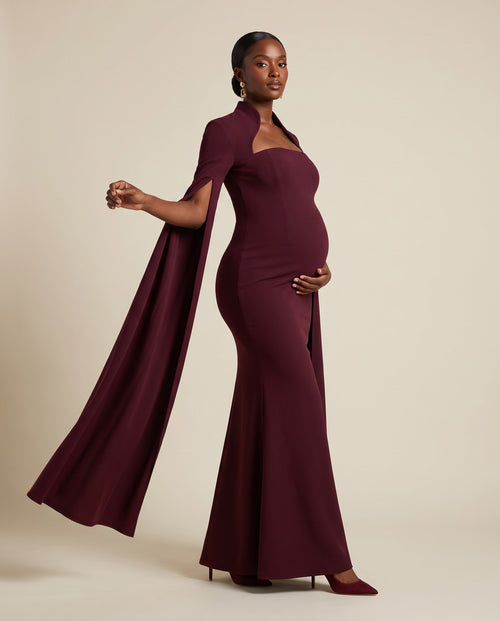Burgundy maternity mermaid gown with attached cape, designed for baby showers and evening wear.