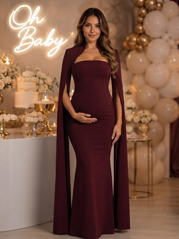 Burgundy strapless mermaid maternity maxi dress with long slit-sleeve cape jacket, designed for baby shower.