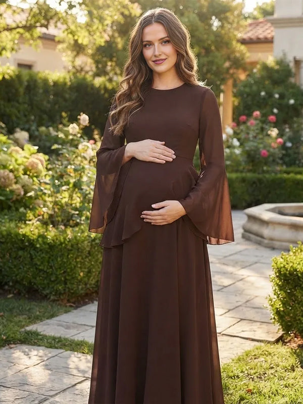 Brown chiffon maternity maxi dress with bell sleeves, ruffle tier and lace-up back, designed for maternity photoshoot.