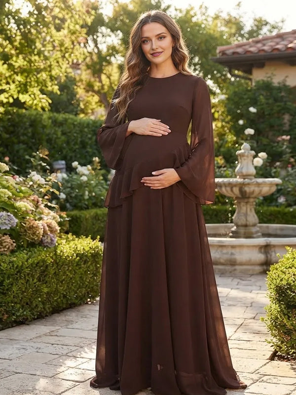 Brown chiffon maternity maxi dress with bell sleeves, ruffle tier and lace-up back, designed for maternity photoshoot.