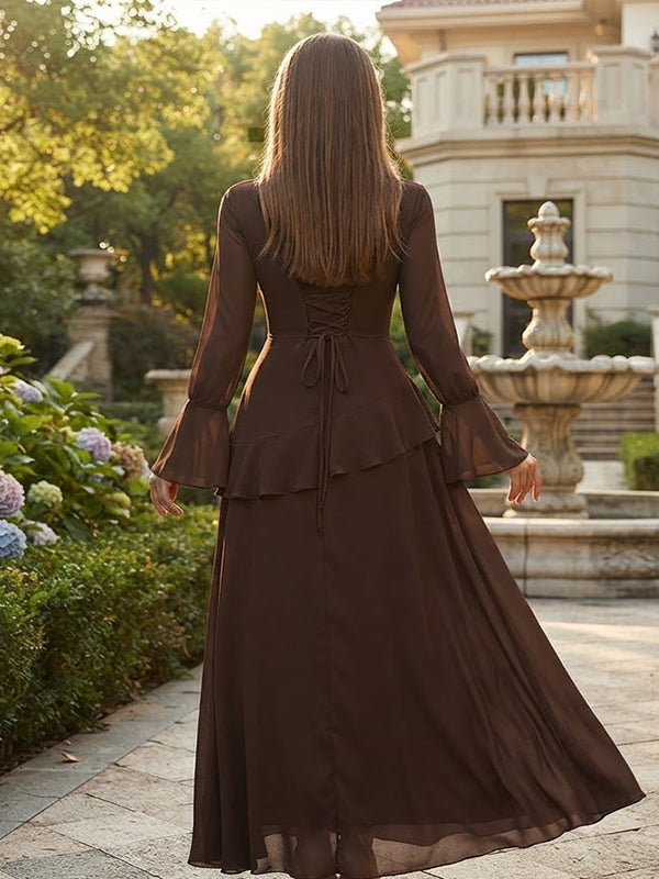 Back view of brown chiffon maternity maxi dress with bell sleeves, ruffle tier and lace-up back, designed for maternity photoshoot.