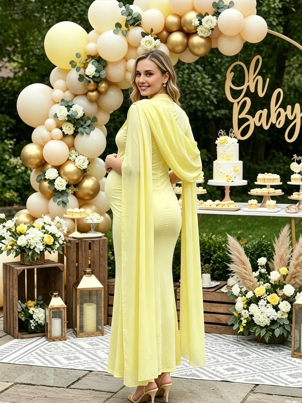 Back view of yellow maternity maxi dress with chiffon cape sleeves and fitted body, designed for baby shower.