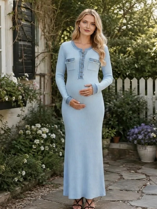 Light blue ribbed knit maternity maxi dress with contrast blue trim, button placket and long sleeves, designed for maternity photoshoot.
