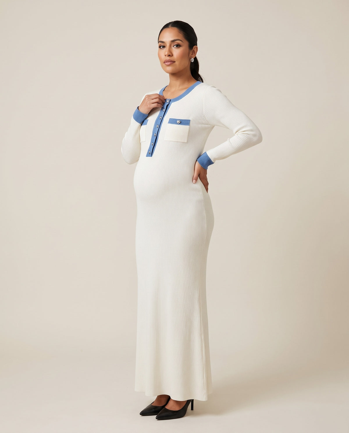 White ribbed knit maternity maxi dress with blue contrast trim and button placket, designed for everyday and photoshoot wear.