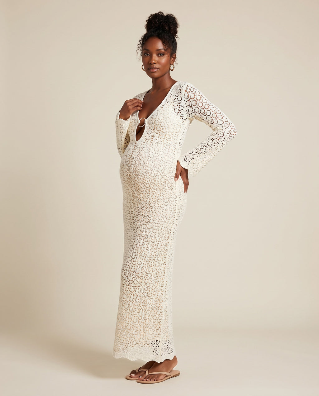 White crochet knit maternity maxi dress with keyhole front and tassel ties, designed for beach babymoon photoshoots.