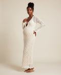 White crochet knit maternity maxi dress with keyhole front and tassel ties, designed for beach babymoon photoshoots.