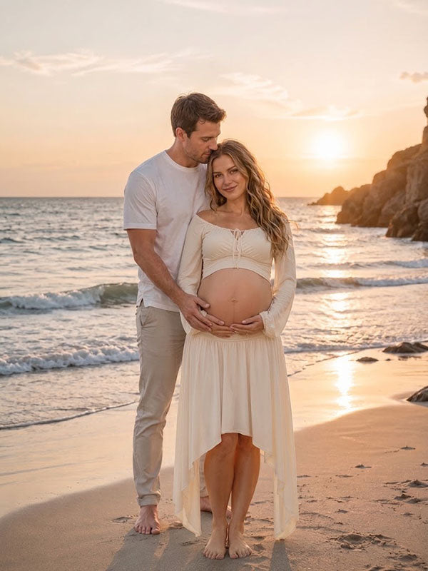 Ivory maternity two-piece set with bell sleeve crop top and high-low skirt, designed for beach photoshoot.