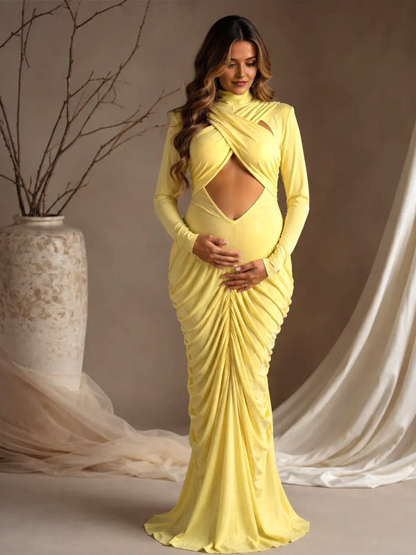 Yellow ruched maternity maxi dress with crossed chest cut-out, mock neck and long sleeves, designed for maternity photoshoot.