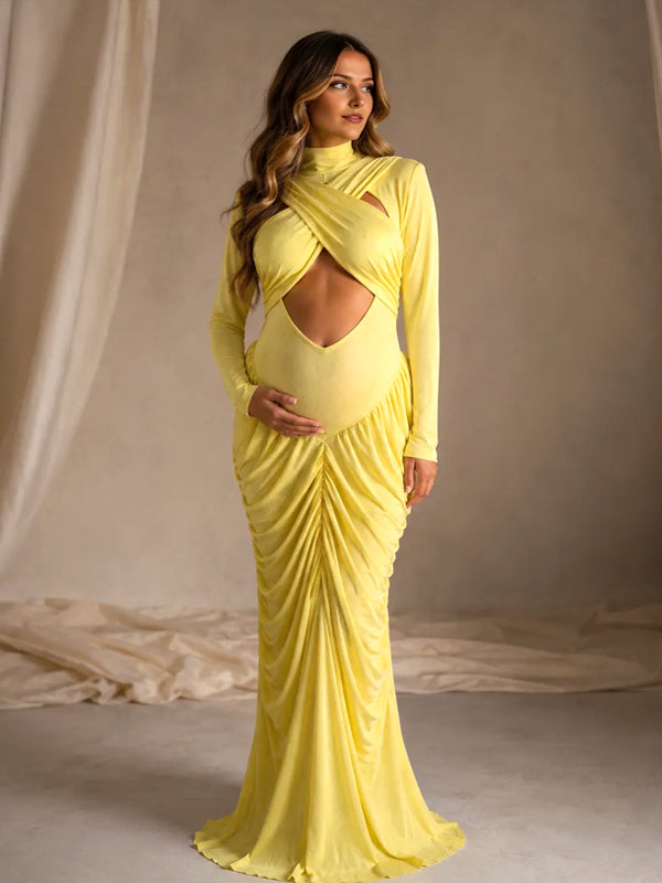 Side view of yellow ruched maternity maxi dress with crossed chest cut-out, mock neck and long sleeves, designed for maternity photoshoot.