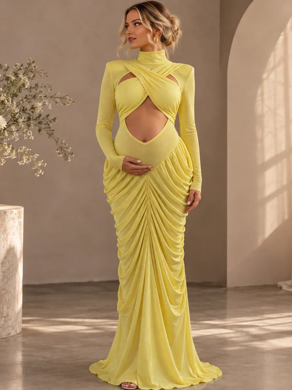 Yellow ruched maternity maxi dress with crossed chest cut-out, mock neck and long sleeves, designed for maternity photoshoot.