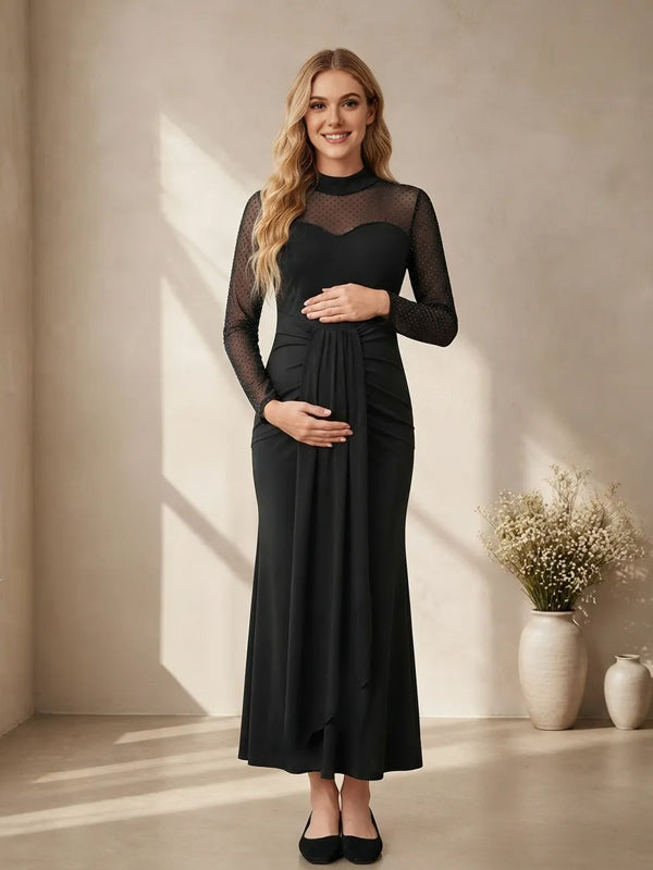 Black maternity maxi dress with sheer dot mesh yoke and sleeves, sweetheart bodice and ruched fitted skirt, designed for baby shower.