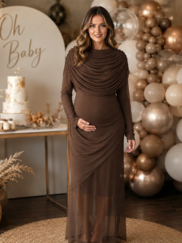 Brown mesh maternity maxi dress with draped cowl neckline, long sleeves and layered sheer hem, designed for baby shower.