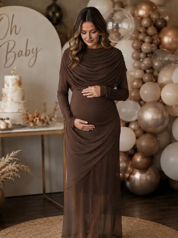 Brown mesh maternity maxi dress with draped cowl neckline, long sleeves and layered sheer hem, designed for baby shower.