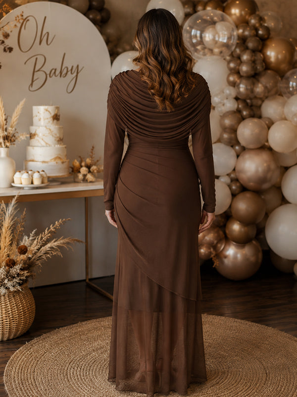 Back view of brown mesh maternity maxi dress with draped cowl neckline, long sleeves and layered sheer hem, designed for baby shower.