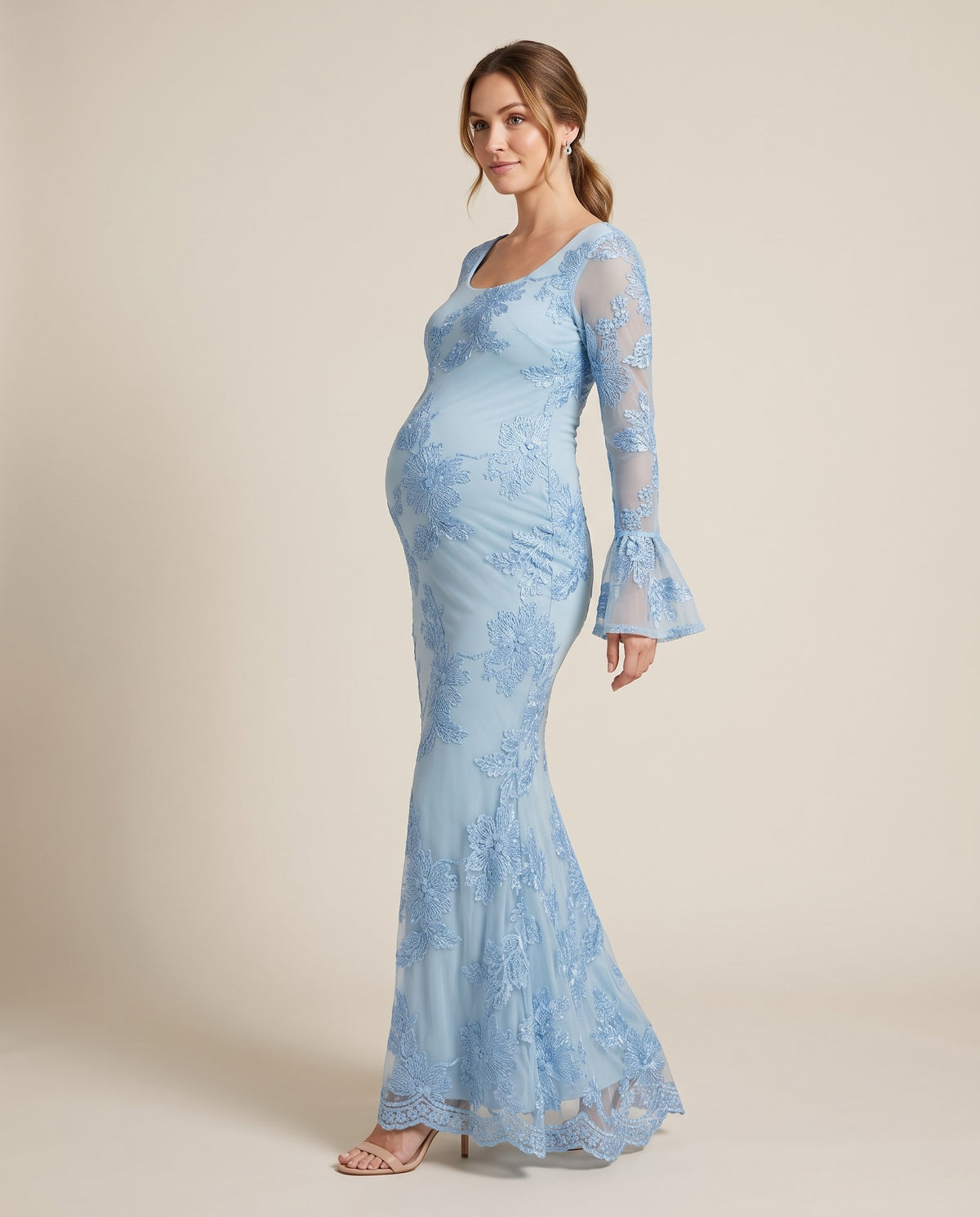 Powder blue embroidered floral mesh maternity maxi dress with bell sleeves, shown on a pregnant model in studio.