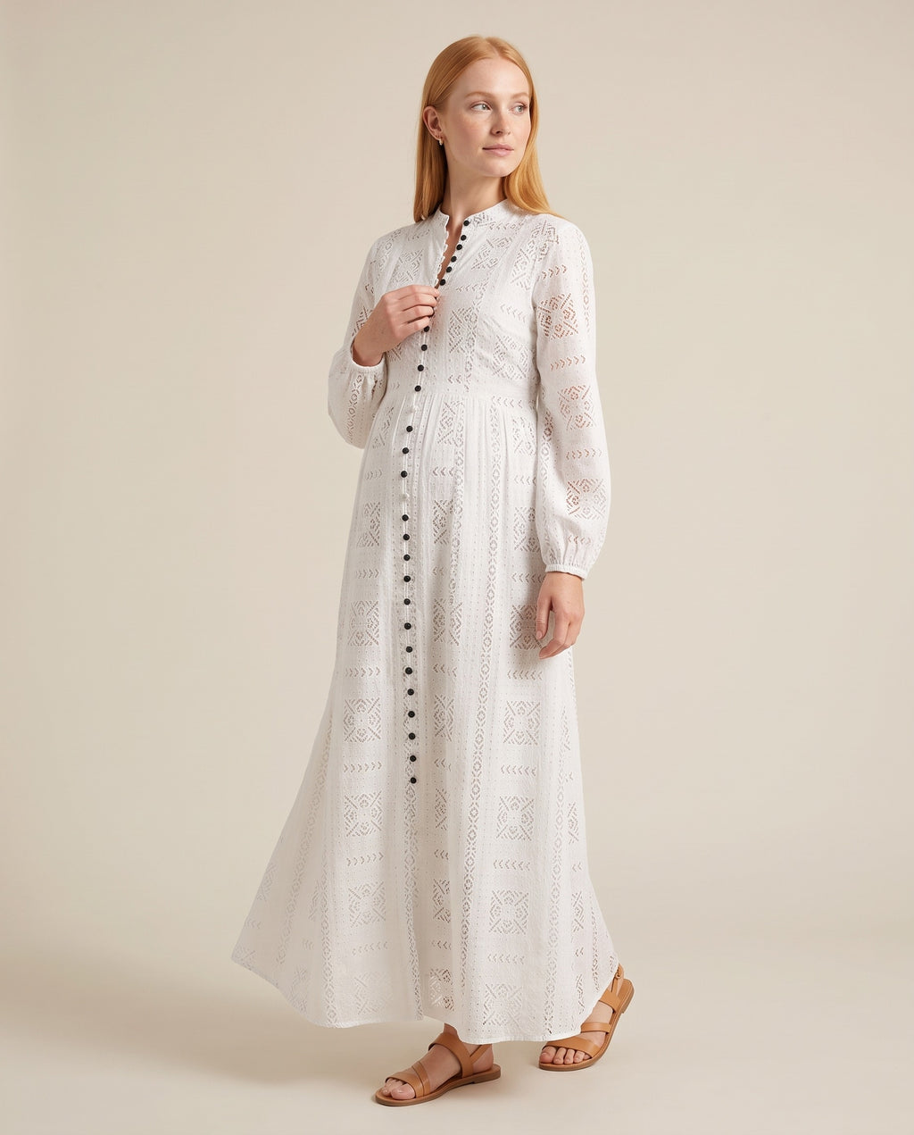 White eyelet cotton maternity maxi dress with dark button front placket, designed for outdoor maternity photoshoots.