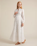 White eyelet cotton maternity maxi dress with dark button front placket, designed for outdoor maternity photoshoots.
