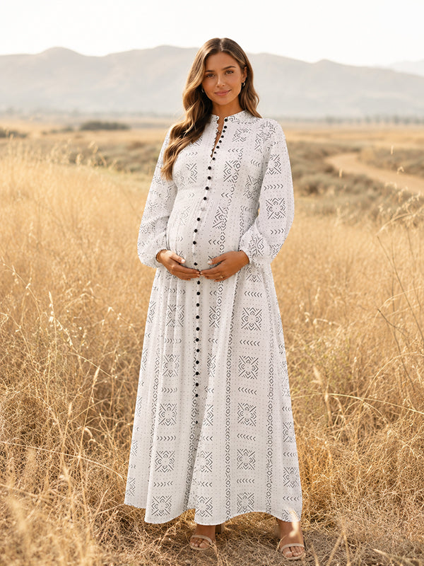 White eyelet embroidered maternity maxi dress with band collar, button front and long sleeves, designed for maternity photoshoot.