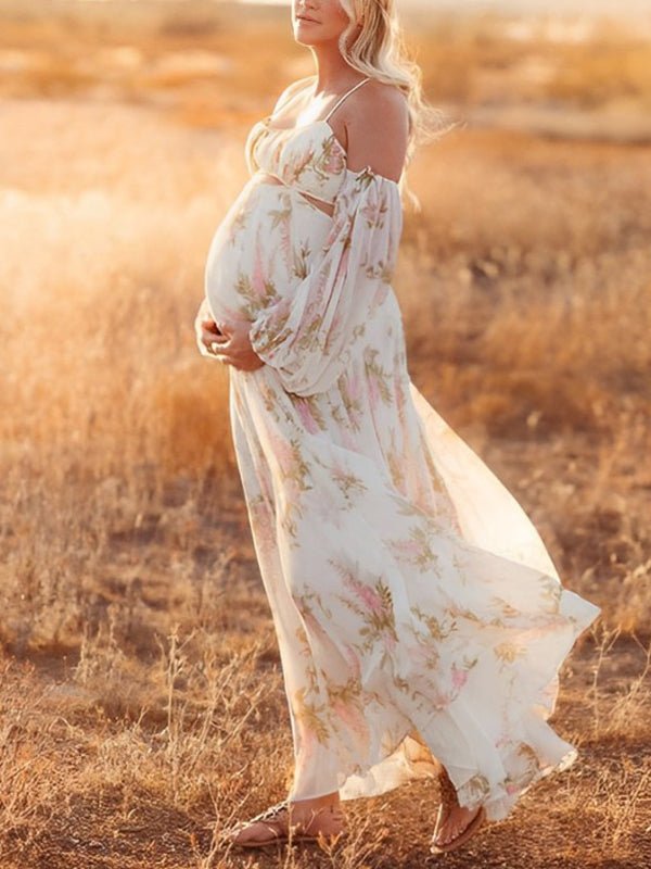 Side view of white floral chiffon maternity maxi dress with off-shoulder cami straps, lantern sleeves, cut-out waist and open back, designed for maternity photoshoot.