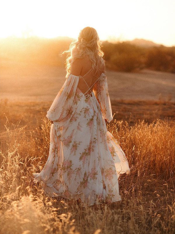 Back view of white floral chiffon maternity maxi dress with off-shoulder cami straps, lantern sleeves, cut-out waist and open back, designed for maternity photoshoot.