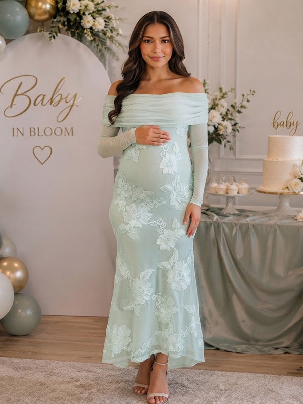 Mint green maternity maxi dress with off-shoulder fold, sheer sleeves and floral embroidery on mesh, designed for baby shower.