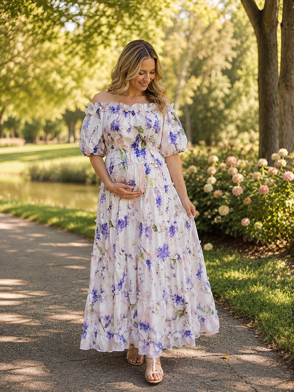 White and lavender floral maternity maxi dress with off-shoulder neckline, puff sleeves, smocked bodice and tiered skirt, designed for baby shower.