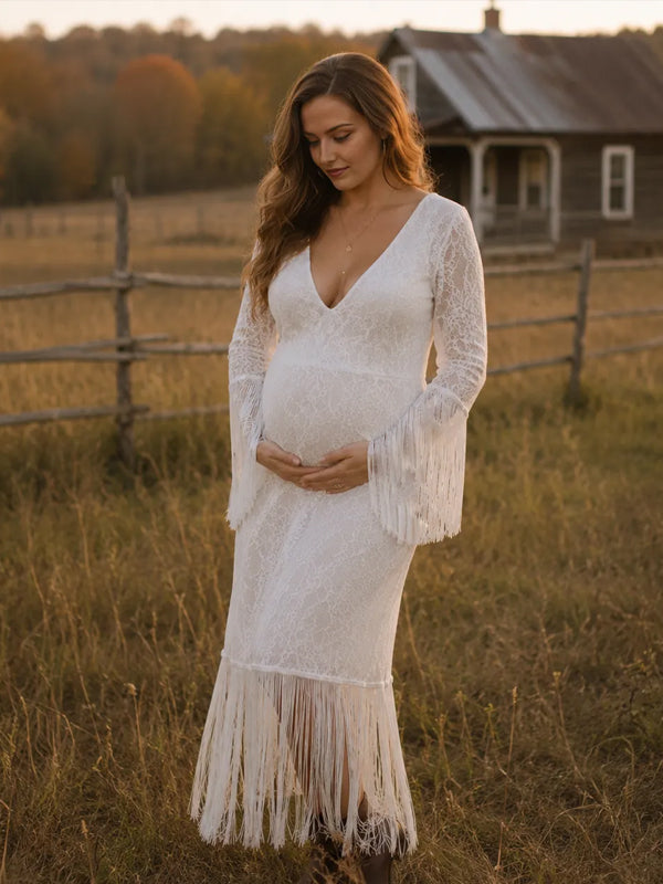 White lace maternity maxi dress with deep V-neck, fringed bell sleeves and fringe hem, designed for maternity photoshoot.