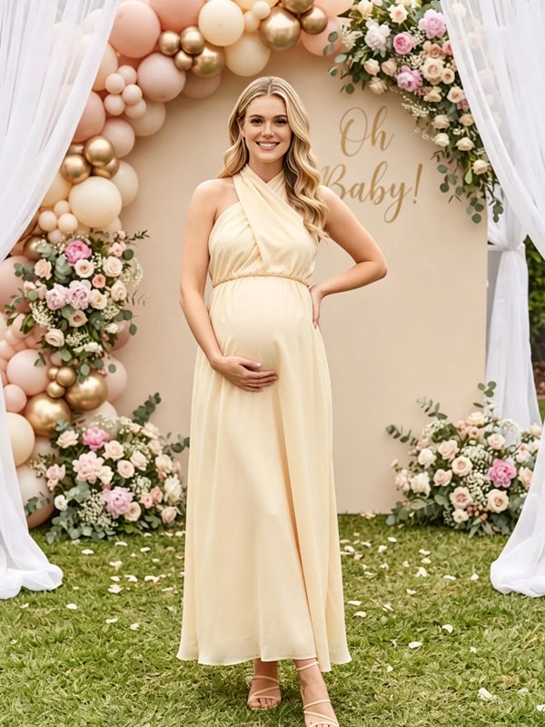 Butter yellow flowy maternity maxi dress with crossover halter neck and tie back, designed for baby shower.