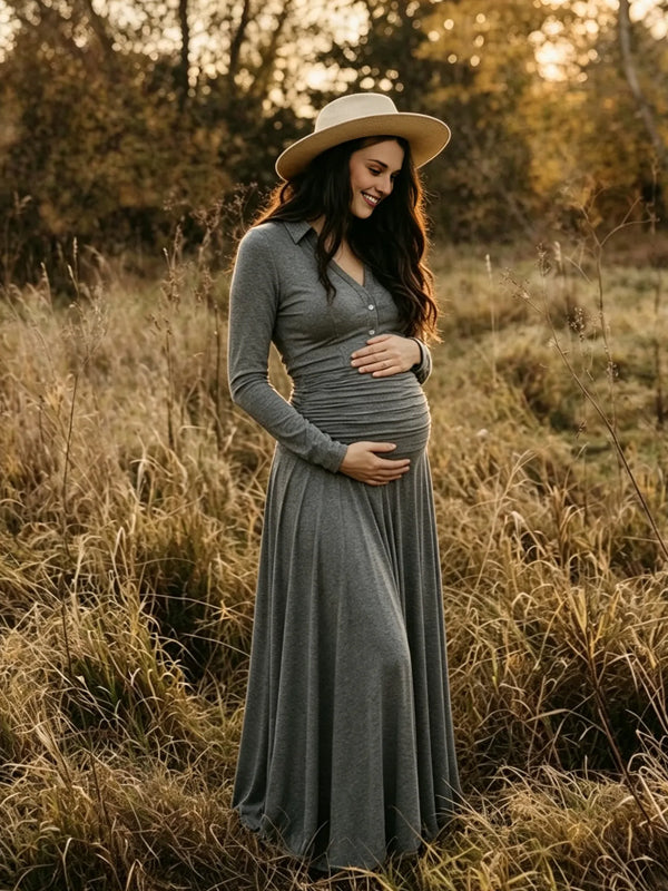 Grey jersey maternity maxi dress with collar, button placket, ruched waist and flowy skirt, designed for maternity photoshoot.