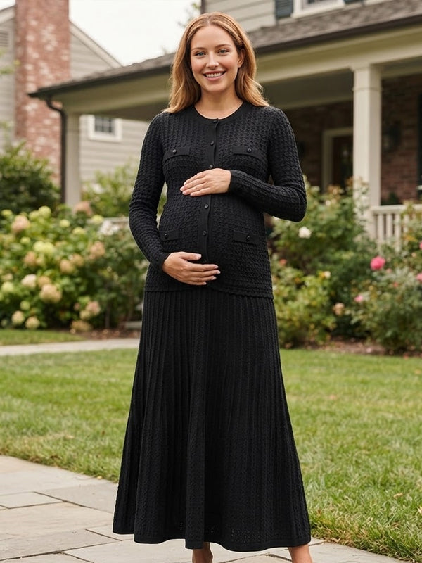 Black knit maternity two-piece set with button cardigan and pleated maxi skirt, designed for maternity photoshoot.
