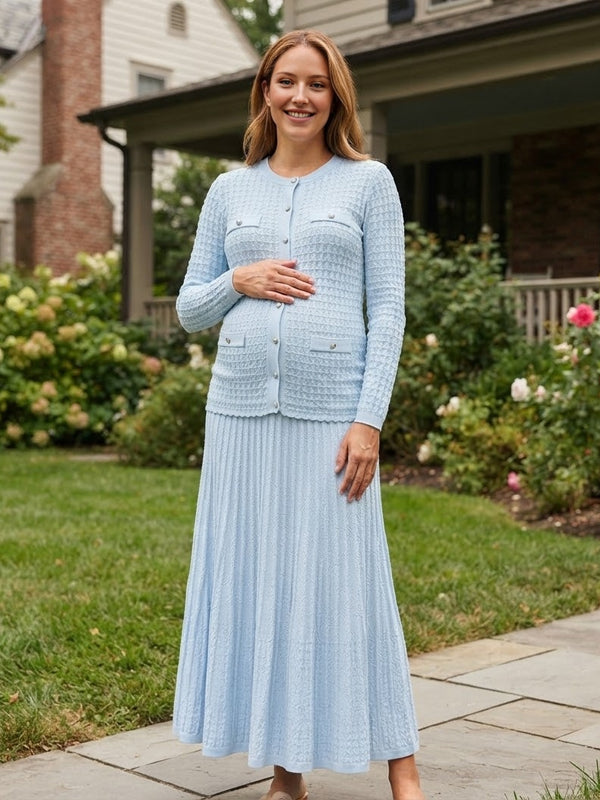 Light blue knit maternity two-piece set with button cardigan and pleated maxi skirt, designed for maternity photoshoot.