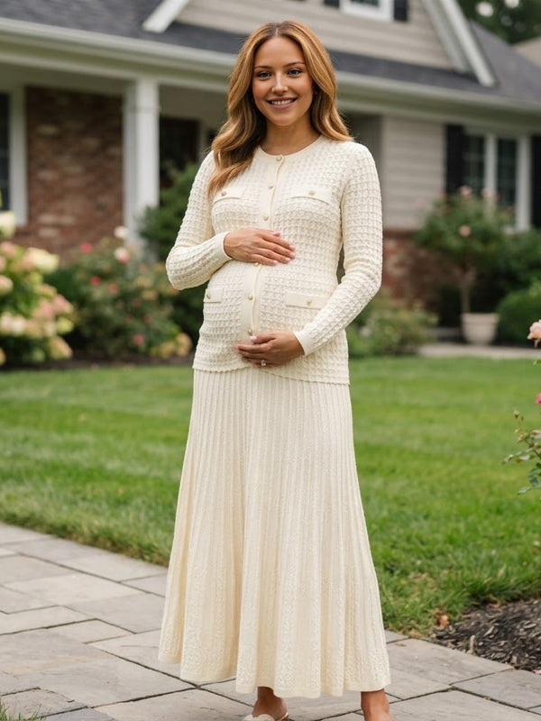 Ivory knit maternity two-piece set with button cardigan and pleated maxi skirt, designed for maternity photoshoot.