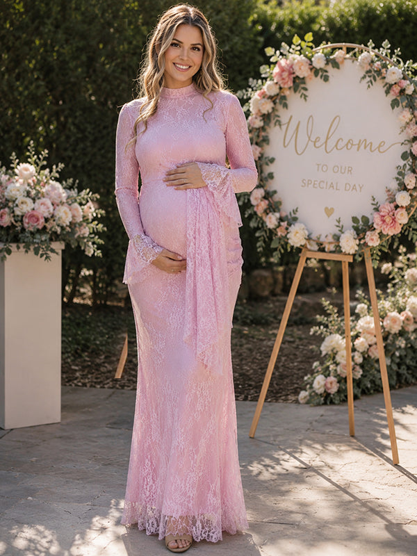 Pink lace maternity maxi dress with high neck, bell sleeves and draped lace panel, designed for baby shower and wedding.