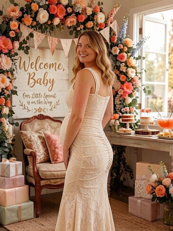 Back view of ivory lace maternity maxi dress with square neck, ruched bodice and high-low ruffle mermaid hem, designed for baby shower.