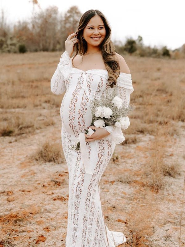 Ivory lace maternity maxi dress with off-shoulder tie-front neckline, bell sleeves and mermaid hem, designed for maternity photoshoot.