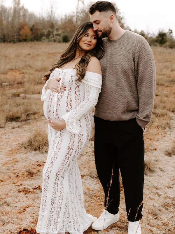 Ivory lace maternity maxi dress with off-shoulder tie-front neckline, bell sleeves and mermaid hem, designed for maternity photoshoot.