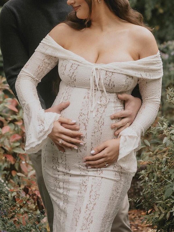Ivory lace maternity maxi dress with off-shoulder tie-front neckline, bell sleeves and mermaid hem, designed for maternity photoshoot.