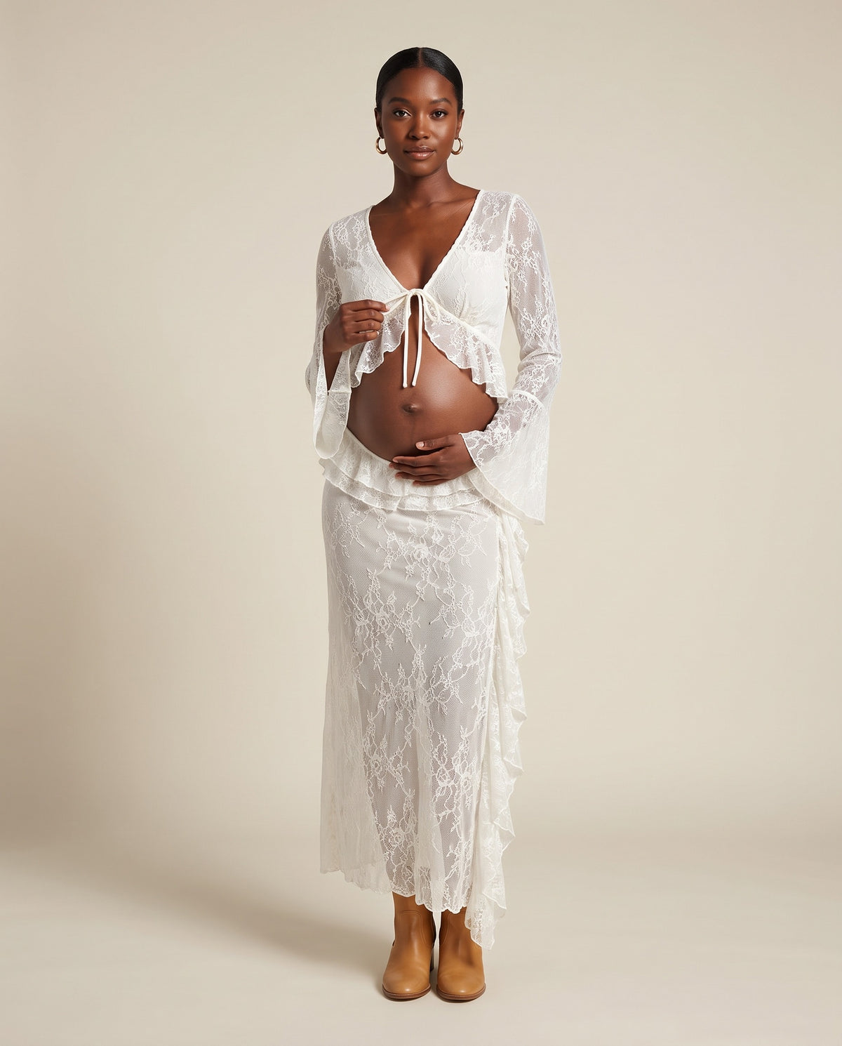 White lace maternity two-piece set with tie front top and ruffle skirt, designed for maternity photoshoots.