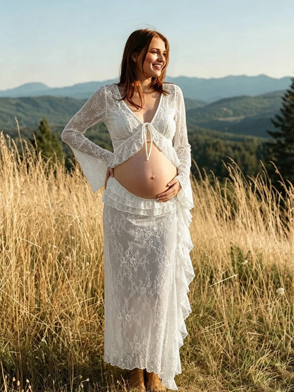 White lace maternity two-piece set with tie-front bell sleeve top and ruffled lace maxi skirt, designed for maternity photoshoot.