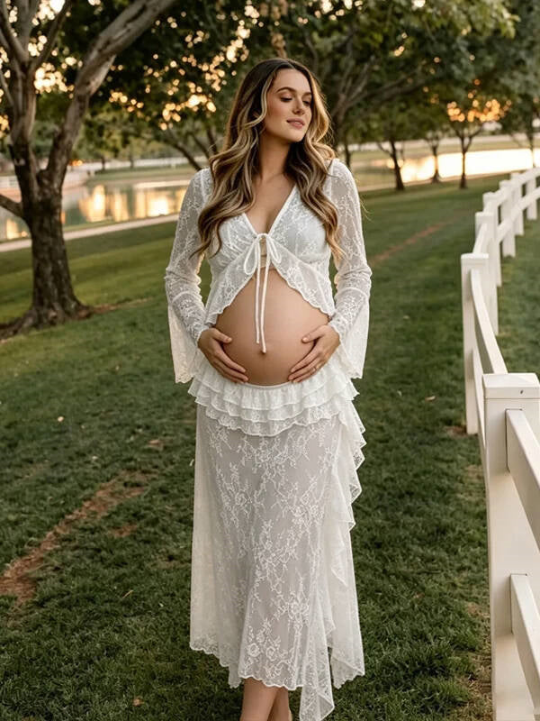 White lace maternity two-piece set with tie-front bell sleeve top and ruffled lace maxi skirt, designed for maternity photoshoot.