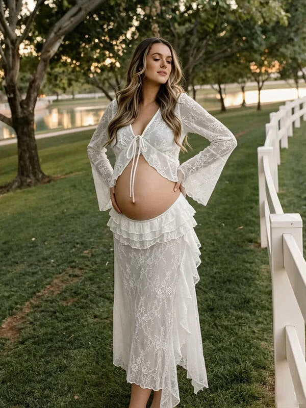 White lace maternity two-piece set with tie-front bell sleeve top and ruffled lace maxi skirt, designed for maternity photoshoot.