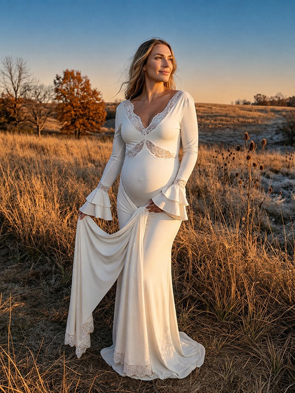 Ivory maternity maxi dress with lace-trimmed V-neck, ruffle bell cuffs, draped sash and mermaid train, designed for maternity photoshoot.